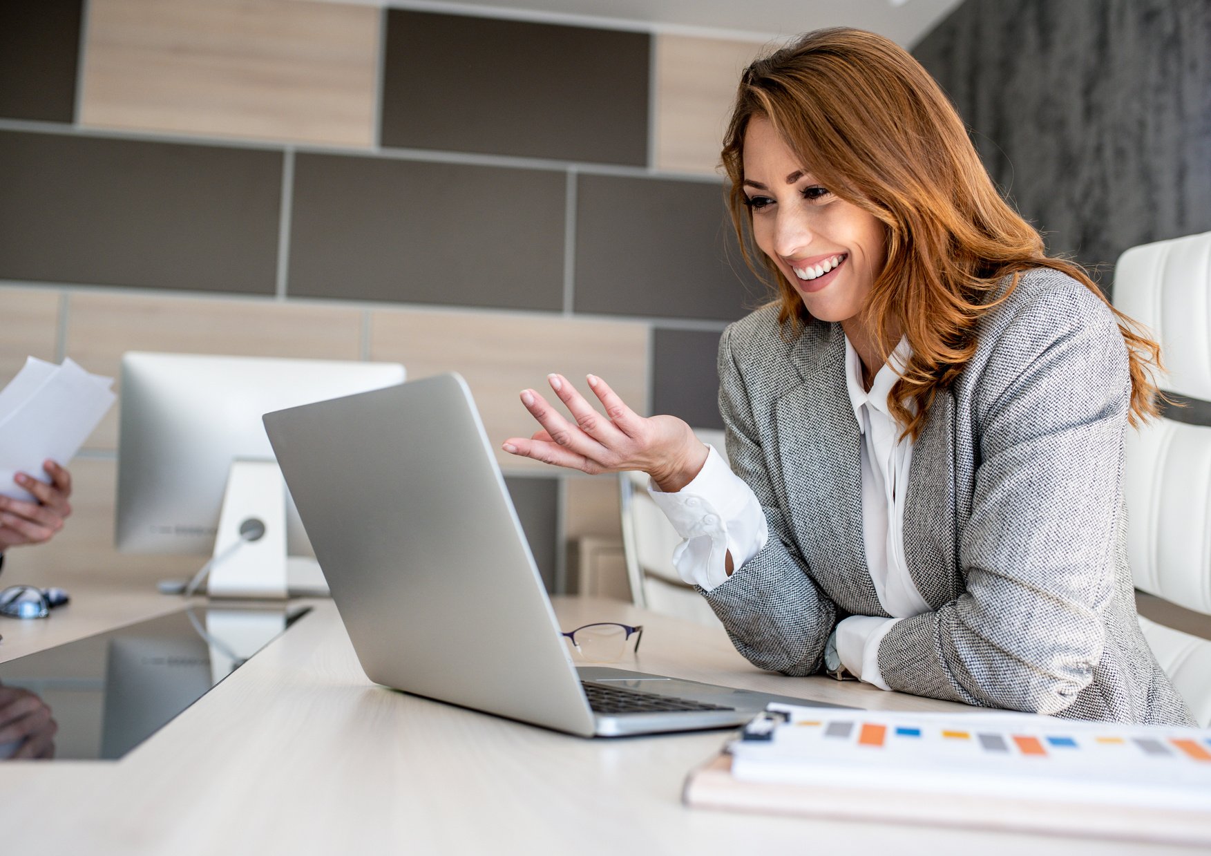 Young business woman talking with customer during an online meeting